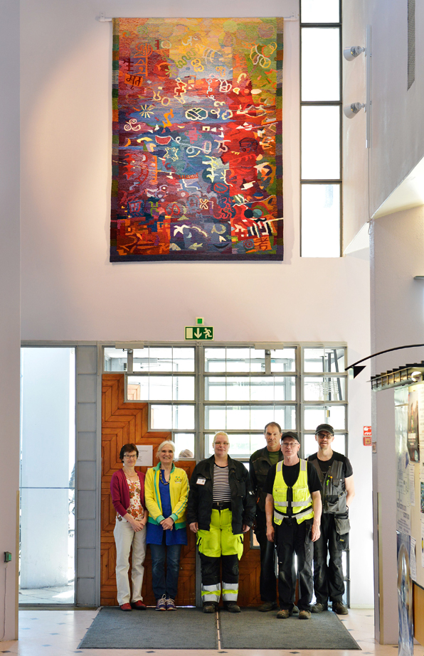Tapestry 'Book Signs' with municipal construction workers, library director Taina Hyvönen and Ariadna Donner